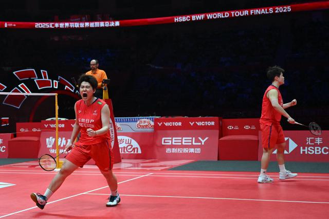 China’s Liu Shengshu and Tan Ning react after a point during their women’s doubles semifinal match against South Korea’s Baek Ha-na and Lee So-hee at the BWF Badminton World Tour Finals at the Hangzhou Olympic Sports Centre Gymnasium in Hangzhou, in eastern China's Zhejiang province on December 20, 2025. (Photo by Jade Gao / AFP)