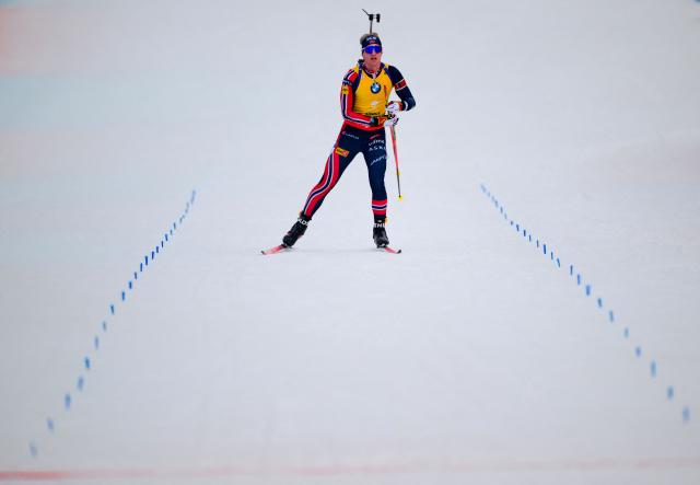 Norway's Johan-Olav Botn celebrates crossing the finish line to win the men's 12,5km pursuit event of the IBU Biathlon World Cup, in Le Grand Bornand, near Annecy, southeastern France, on December 20, 2025. (Photo by Olivier CHASSIGNOLE / AFP)