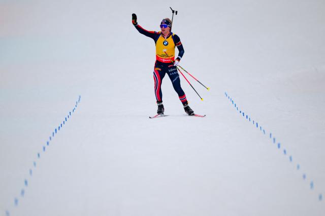 Norway's Johan-Olav Botn celebrates crossing the finish line to win the men's 12,5km pursuit event of the IBU Biathlon World Cup, in Le Grand Bornand, near Annecy, southeastern France, on December 20, 2025. (Photo by Olivier CHASSIGNOLE / AFP)