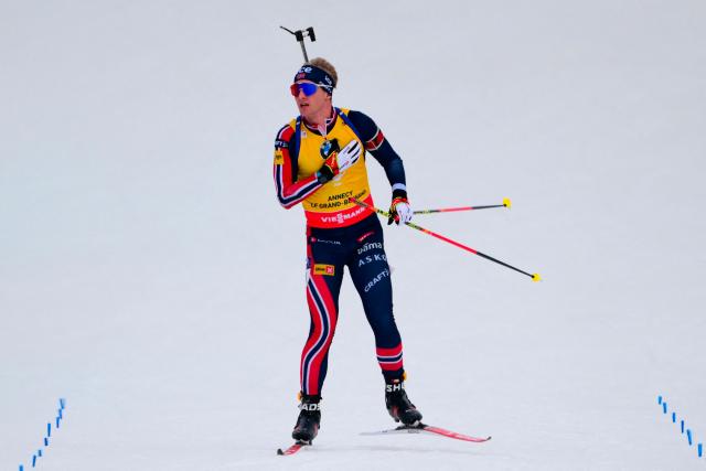 Norway's Johan-Olav Botn celebrates skiing to the finish line to win the men's 12,5km pursuit event of the IBU Biathlon World Cup, in Le Grand Bornand, near Annecy, southeastern France, on December 20, 2025. (Photo by Olivier CHASSIGNOLE / AFP)