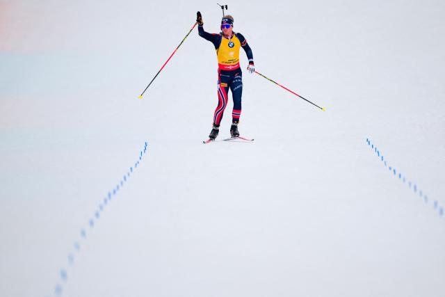 Norway's Johan-Olav Botn celebrates skiing to the finish line to win the men's 12,5km pursuit event of the IBU Biathlon World Cup, in Le Grand Bornand, near Annecy, southeastern France, on December 20, 2025. (Photo by Olivier CHASSIGNOLE / AFP)