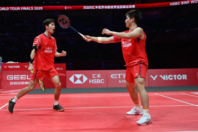 China’s Liang Weikeng and Wang Chang react after a point during their men’s doubles semifinal match against India’s Satwiksairaj Rankireddy and Chirag Shetty at the BWF Badminton World Tour Finals at the Hangzhou Olympic Sports Centre Gymnasium in Hangzhou, in eastern China's Zhejiang province on December 20, 2025. (Photo by Jade Gao / AFP)