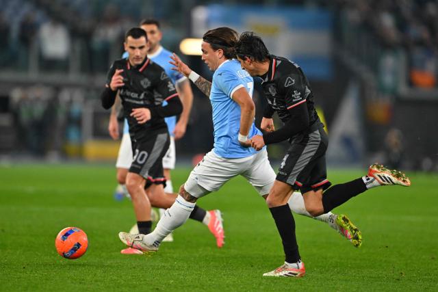 Lazio's Italian defender #03 Luca Pellegrini (C) fights for the ball with Cremonese's Italian defender #04 Tommaso Barbieri (R) during the Italian Serie A football match between Lazio and Cremonese at the Olympic Stadium in Rome on December 20, 2025. (Photo by Andreas SOLARO / AFP)