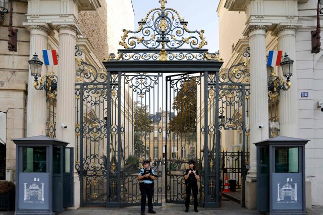 (FILES) Police officers stand guard at the entrance of the French interior ministry, place Beauvau in Paris on September 6, 2023. The 22-year-old man suspected of hacking the servers of France's Interior Ministry has been indicted and placed in pre-trial detention, according to a judicial source, on December 20, 2025. (Photo by Ludovic MARIN / AFP)