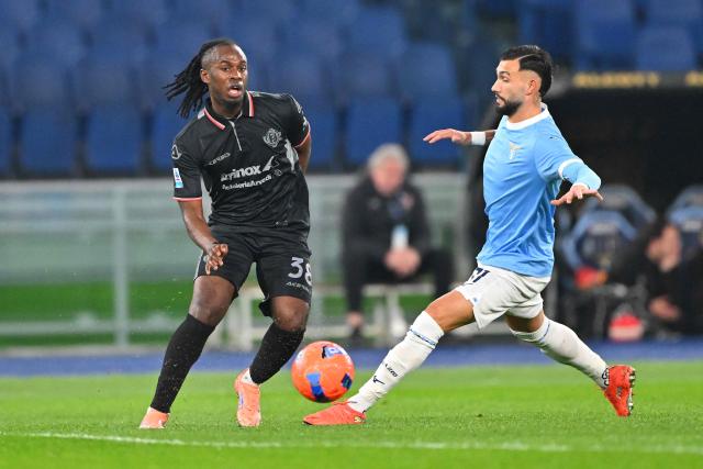 Cremonese's French midfielder #38 Warren Bondo (L) and Lazio's Argentine forward #11 Valentin Castellanos (R) fight for the ball during the Italian Serie A football match between Lazio and Cremonese at the Olympic Stadium in Rome on December 20, 2025. (Photo by Andreas SOLARO / AFP)