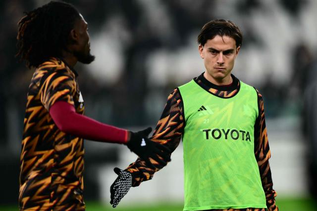 Roma's Argentine forward #21 Paulo Dybala (R) reacts during the warm up ahead of the Italian Serie A football match between Juventus and AS Roma at the Allianz stadium in Turin, northern Italy, on December 20, 2025. (Photo by MARCO BERTORELLO / AFP)