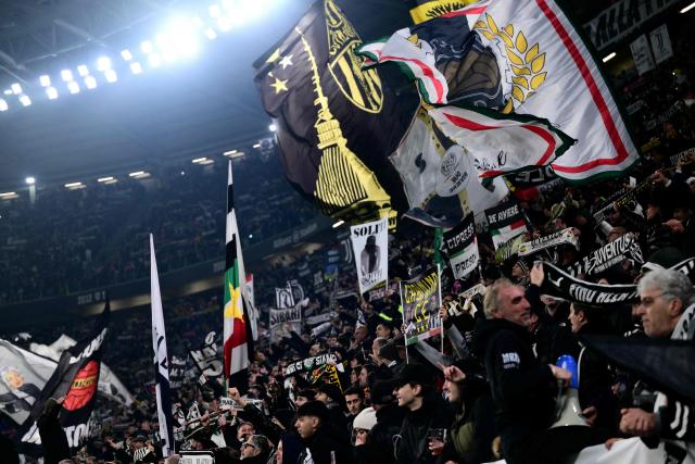 Juventus' supporters cheer their team on from the stands ahead of the Italian Serie A football match between Juventus and AS Roma at the Allianz stadium in Turin, northern Italy, on December 20, 2025. (Photo by Marco BERTORELLO / AFP)