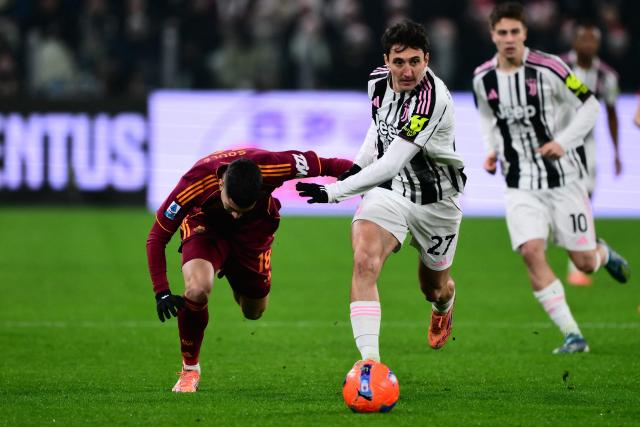 Roma's Argentine forward #18 Matias Soule (L) and Juventus' Italian defender #27 Andrea Cambiaso (R) fight for the ball during the Italian Serie A football match between Juventus and AS Roma at the Allianz stadium in Turin, northern Italy, on December 20, 2025. (Photo by MARCO BERTORELLO / AFP)