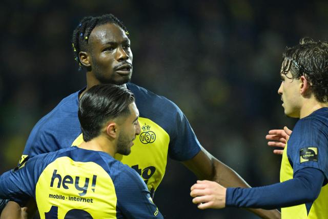 Union's Promise David (up, L) celebrates with teammates after scoring a goal during the Belgian Pro League football match between Royale Union Saint-Gilloise and Zulte Waregem in Brussels, on December 20, 2025. (Photo by DAVID PINTENS / Belga / AFP) / Belgium OUT