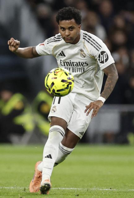 Real Madrid's Brazilian forward #11 Rodrygo shoots during the Spanish league football match between Real Madrid CF and Sevilla FC at Santiago Bernabeu Stadium in Madrid on December 20, 2025. (Photo by Oscar DEL POZO / AFP)