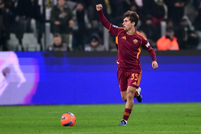 Roma's Italian midfielder #35 Tommaso Baldanzi celebrates after scoring Roma's first goal during the Italian Serie A football match between Juventus and AS Roma at the Allianz stadium in Turin, northern Italy, on December 20, 2025. (Photo by MARCO BERTORELLO / AFP)