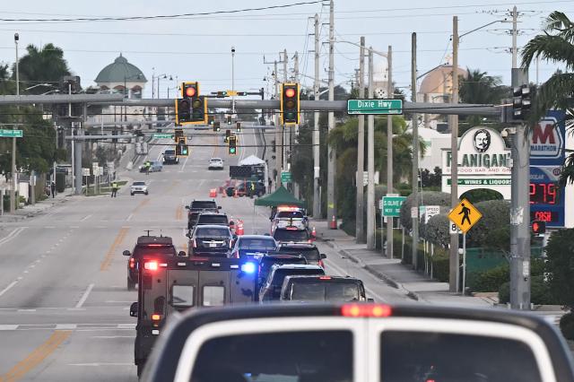 The motorcade with US President Donald Trump passes returns to Mar-a-Lago club in Palm Beach, Florida on December 20, 2025. (Photo by ANDREW CABALLERO-REYNOLDS / AFP)