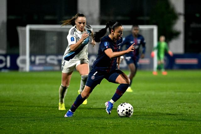 Paris FC’s French defender #03 Lou Bogaert (L) fights for the ball with PSG’s French defender #07 Sakina Karchaoui (R) during the French D1 women's football match between Paris Saint-Germain and Paris FC at Campus Paris Saint-Germain in Poissy, western of Paris on December 20, 2025. (Photo by Julie SEBADELHA / AFP)