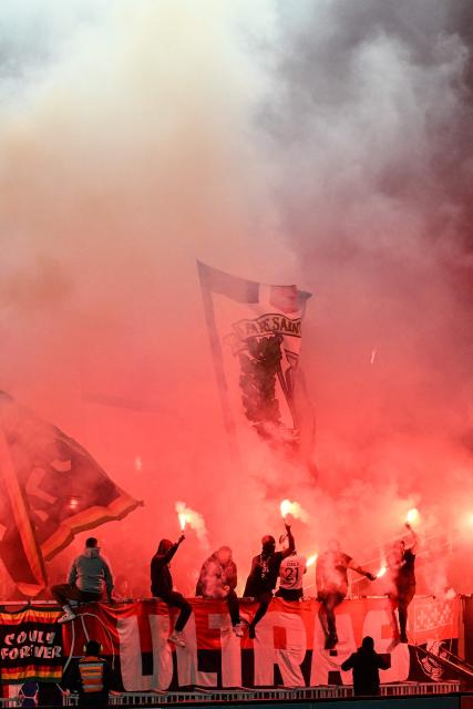 Paris Saint-Germain's supporters light flares as they cheer their team on from the stands during the French Cup round of 64 football match between Fontenay-le-Comte and Paris Saint-Germain (PSG) at La Beaujoire stadium in Nantes, western France, on December 20, 2025. (Photo by Sebastien Salom-Gomis / AFP)