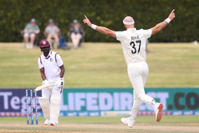 New Zealand’s Michael Rae celebrates the wicket of West Indies Kemar Roach during day four of the 3rd international Test cricket match between New Zealand and West Indies at Bay Oval in Mount Maunganui, Tauranga, New Zealand on December 21, 2025. (Photo by Michael Bradley / AFP)