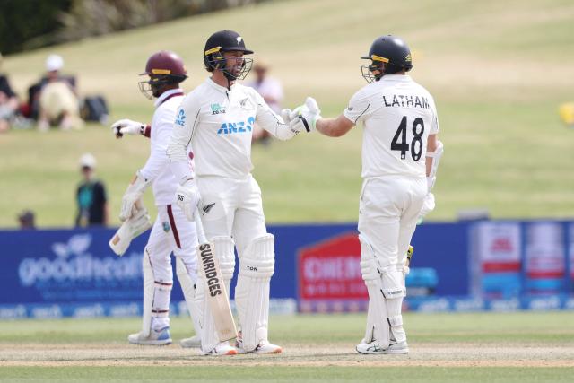 New Zealand’s Devon Conway (L) and Tom Latham touch gloves during day four of the 3rd international Test cricket match between New Zealand and West Indies at Bay Oval in Mount Maunganui on December 21, 2025. (Photo by Michael Bradley / AFP)