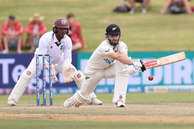 New Zealand’s Kane Williamson bats watched by West Indies Tevin Imlach (L) during day four of the 3rd international Test cricket match between New Zealand and West Indies at Bay Oval in Mount Maunganui on December 21, 2025. (Photo by Michael Bradley / AFP)