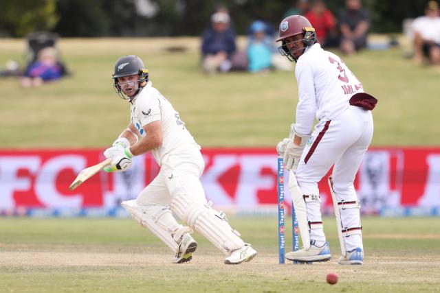 New Zealand’s Tom Latham bats watched by West Indies' Tevin Imlach (R) during day four of the 3rd international Test cricket match between New Zealand and West Indies at Bay Oval in Mount Maunganui on December 21, 2025. (Photo by Michael Bradley / AFP)