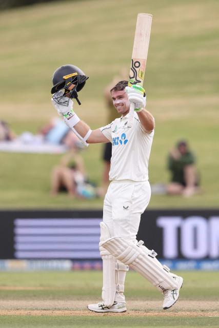 New Zealand’s Tom Latham celebrates his century during day four of the 3rd international Test cricket match between New Zealand and West Indies at Bay Oval in Mount Maunganui on December 21, 2025. (Photo by Michael Bradley / AFP)