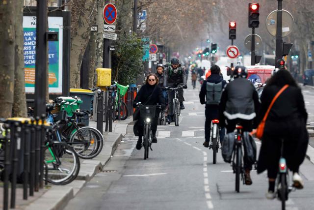 (FILES) Bikers ride on a bicycle path at boulevard Sebastopol, in Paris, on February 23, 2023, the most used bike path in Paris. The construction of the cycling paths in the Ile-de-France region has slowed down due to budget constraints affecting the departments, which partially fund these large-scale projects. Since February 2020, 241 km of cycle paths separated by curbs have been built, according to the public agency Île-de-France Mobilités, primarily under the auspices of the departments. (Photo by LUDOVIC MARIN / AFP)