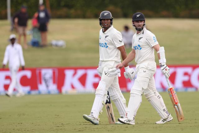 New Zealand’s Rachin Ravindra (L) and Kane Williamson leave the field at the end of New Zealand’s second innings during day four of the 3rd international Test cricket match between New Zealand and West Indies at Bay Oval in Mount Maunganui on December 21, 2025. (Photo by Michael Bradley / AFP)