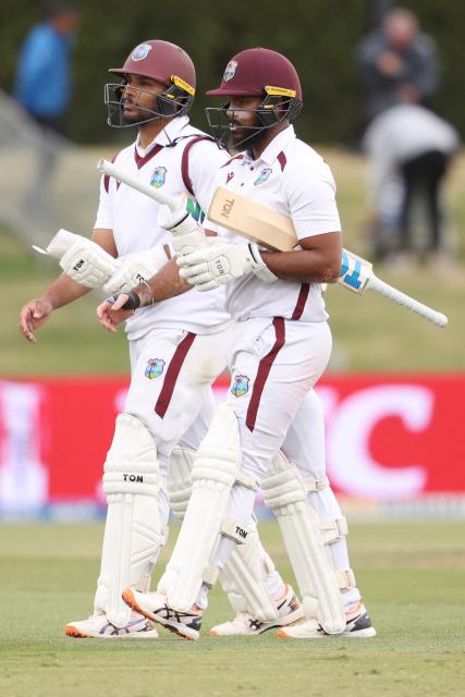 West Indies' Brandon King (L) and John Campbell walk off at the end of the day's play during day four of the 3rd international Test cricket match between New Zealand and West Indies at Bay Oval in Mt Maunganui on December 21, 2025. (Photo by Michael Bradley / AFP)