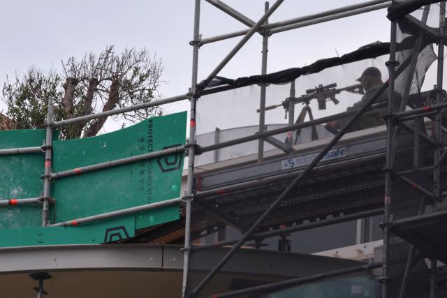 A police sniper is seen on a roof as he secures the area during the memorial held for the victims of a shooting at Bondi Beach in Sydney on December 21, 2025. A father and his son are accused of spraying bullets into the family-thronged Hanukkah celebration at Sydney's most famous beach on December 14, allegedly inspired by "Islamic State ideology". (Photo by DAVID GRAY / AFP)