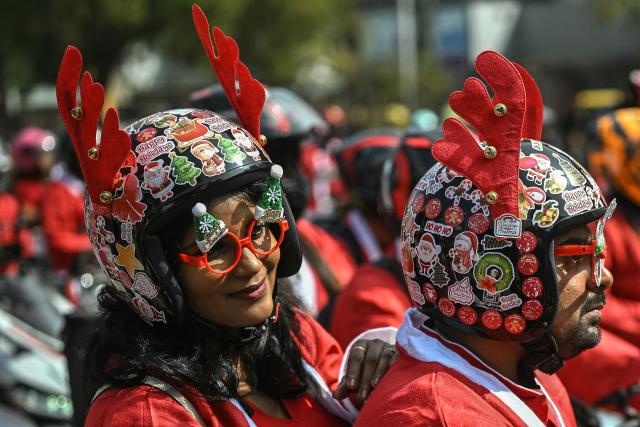 Motorcyclists dressed as Santa Claus take part in a Christmas-themed rally in support of specially abled children, marking the start of Christmas festivities in Bengaluru on December 21, 2025. (Photo by Idrees MOHAMMED / AFP)