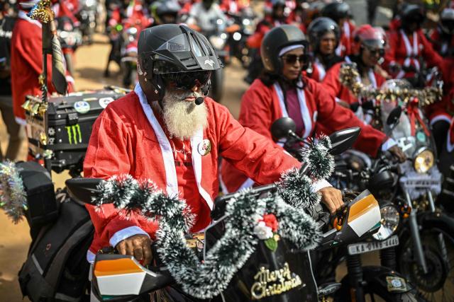 Motorcyclists dressed as Santa Claus take part in a Christmas-themed rally in support of specially abled children, marking the start of Christmas festivities in Bengaluru on December 21, 2025. (Photo by Idrees MOHAMMED / AFP)