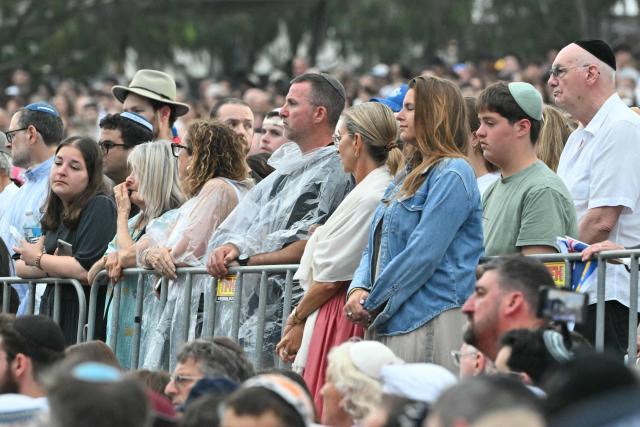 Mourners attend the memorial held for the victims of a shooting at Bondi Beach in Sydney on December 21, 2025. A father and his son are accused of spraying bullets into the family-thronged Hanukkah celebration at Sydney's most famous beach on December 14, allegedly inspired by "Islamic State ideology". (Photo by Saeed KHAN / AFP)