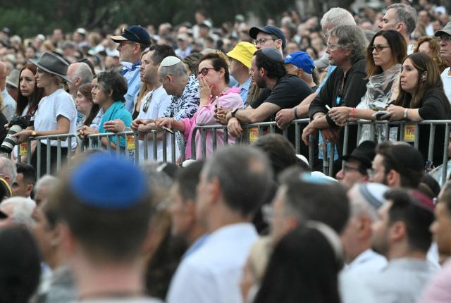 Mourners attend the memorial held for the victims of a shooting at Bondi Beach in Sydney on December 21, 2025. A father and his son are accused of spraying bullets into the family-thronged Hanukkah celebration at Sydney's most famous beach on December 14, allegedly inspired by "Islamic State ideology". (Photo by Saeed KHAN / AFP)