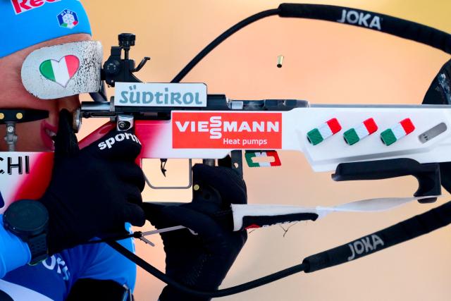 Italy's Dorothea Wierer fires her rifle as she trains during the women's 12,5km mass start event of the IBU Biathlon World Cup, in Le Grand Bornand, near Annecy, southeastern France, on December 21, 2025. (Photo by Olivier CHASSIGNOLE / AFP)