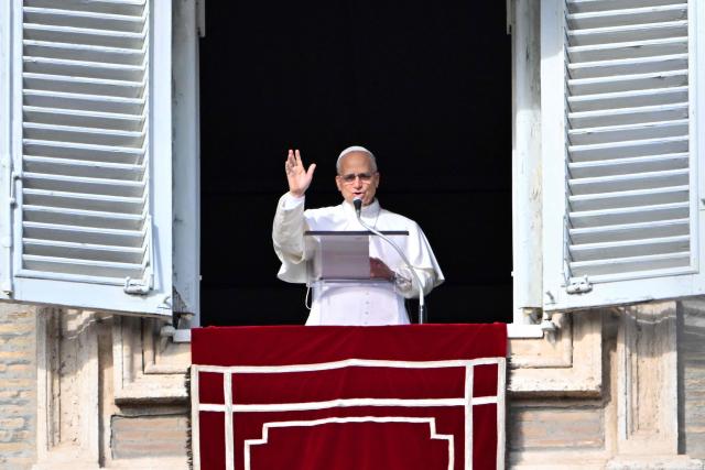 Pope Leo XIV adresses the crowd from a window of the apostolic palace overlooking St. Peter's Square during the Angelus prayer in The Vatican on December 21, 2025. (Photo by Andreas SOLARO / AFP)