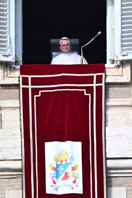 Pope Leo XIV arrives at the window of the apostolic palace overlooking St. Peter's Square during the Angelus prayer in The Vatican on December 21, 2025. (Photo by Andreas SOLARO / AFP)