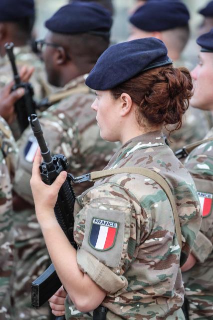 French soldiers wait for the arrival of the French president ahead of a ceremony at the 5th Cuirassier Regiment's base in Zayed Military City, near Abu Dhabi, on December 21, 2025. President Emmanuel Macron arrived in the United Arab Emirates on December 21 to celebrate Christmas with French troops and to discuss bilateral ties with the Gulf state, as France hopes for more cooperation in its fight against drug trafficking. (Photo by Ludovic MARIN / AFP)