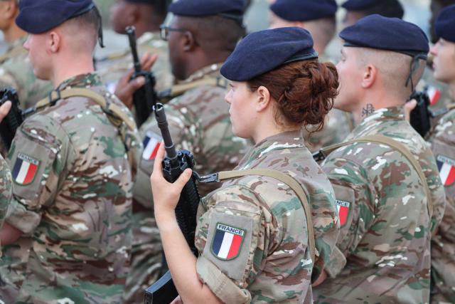 French soldiers wait for the arrival of the French president ahead of a ceremony at the 5th Cuirassier Regiment's base in Zayed Military City, near Abu Dhabi, on December 21, 2025. President Emmanuel Macron arrived in the United Arab Emirates on December 21 to celebrate Christmas with French troops and to discuss bilateral ties with the Gulf state, as France hopes for more cooperation in its fight against drug trafficking. (Photo by Ludovic MARIN / AFP)