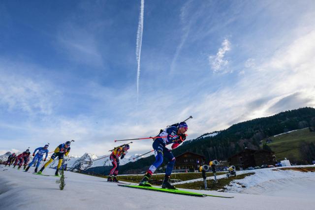 France's Quentin Fillon Maillet (R) competes during the men's 15km mass start event of the IBU Biathlon World Cup, in Le Grand Bornand, near Annecy, southeastern France, on December 21, 2025. (Photo by Olivier CHASSIGNOLE / AFP)