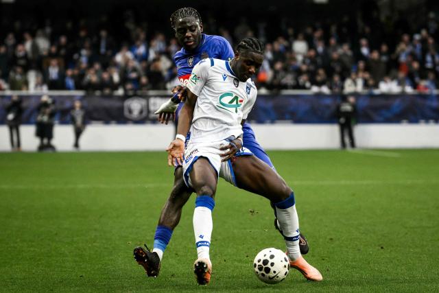 Auxerre's Ghanaian forward #07 Ibrahim Osman (front) fights for the ball with Monaco's French defender #02 Christian Mawissa (rear)  during the French Cup round of 64 football match between AJ Auxerre and AS Monaco at the Abbe-Deschamps Stadium in Auxerre, central France, on December 21, 2025. (Photo by ARNAUD FINISTRE / AFP)