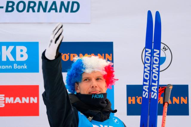 Third placed Norway's Vetle Sjaastad Christiansen celebrates on the podium of the men's 15km mass start event of the IBU Biathlon World Cup, in Le Grand Bornand, near Annecy, southeastern France, on December 21, 2025. (Photo by Olivier CHASSIGNOLE / AFP)