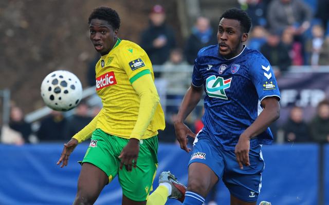 Concarneau's French defender #06 Djessine Seba fights for the ball with Nantes' French midfielder #06 Bahmed Deuff during the French Cup round of 64 football match between Concarneau and Nantes at the Guy-Piriou Stadium in Concarneau, western France, on December 21, 2025. (Photo by Fred TANNEAU / AFP)