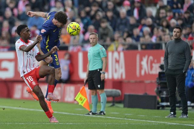 Girona's Colombian forward #10 Yaser Asprilla and Atletico Madrid's Italian defender #03 Matteo Ruggeri fight for the ball during the Spanish league football match between Girona FC and Club Atletico de Madrid at Montilivi Stadium in Girona on December 21, 2025. (Photo by MANAURE QUINTERO / AFP)