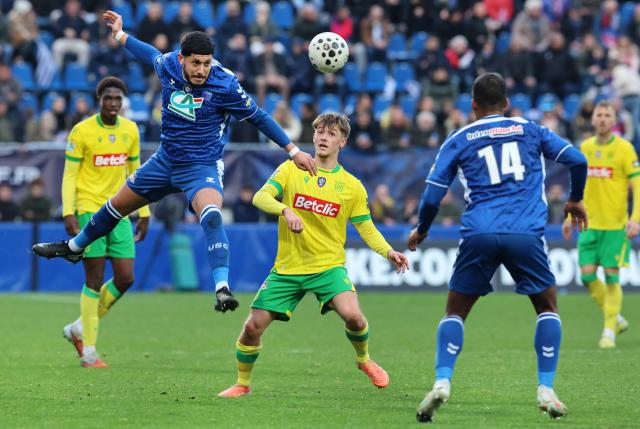 Concarneau's French forward #21 Yanis El Khemeri fights for the ball with Nantes' French midfielder Johann Lepenant during the French Cup round of 64 football match between Concarneau and Nantes at the Guy-Piriou Stadium in Concarneau, western France on December 21, 2025. (Photo by Fred TANNEAU / AFP)