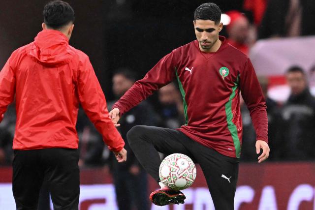 Morocco's defender #02 Achraf Hakimi warms up before the Africa Cup of Nations (CAN) group A  football match between Morocco and Comoros at Prince Moulay Abdellah Stadium in Rabat on December 21, 2025. (Photo by SEBASTIEN BOZON / AFP)