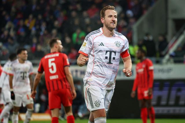 Bayern Munich's English forward #09 Harry Kane celebrates scoring his team's fourth goal during the German first division Bundesliga football match between  FC Heidenheim and FC Bayern Munich in Heidenheim, southern Germany, on December 21, 2025. Bayern Munich won the match 4-0. (Photo by Karl-Josef HILDENBRAND / AFP) / DFL REGULATIONS PROHIBIT ANY USE OF PHOTOGRAPHS AS IMAGE SEQUENCES AND/OR QUASI-VIDEO