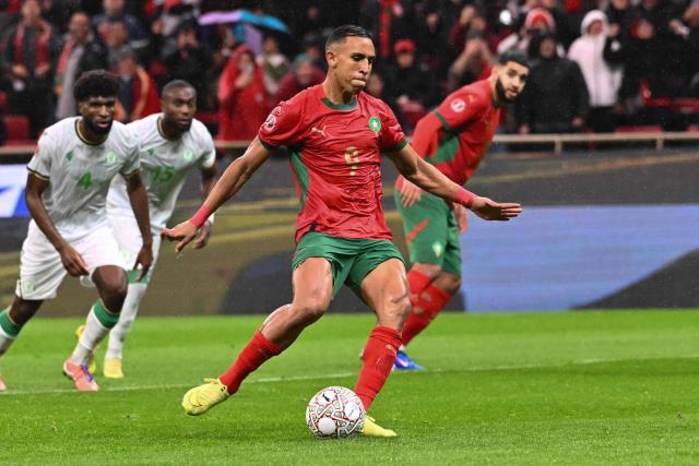 Morocco's forward #09 Soufiane Rahimi kicks a penalty during the Africa Cup of Nations (CAN) group A  football match between Morocco and Comoros at Prince Moulay Abdellah Stadium in Rabat on December 21, 2025. (Photo by SEBASTIEN BOZON / AFP)