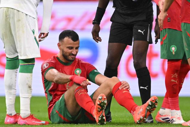 Morocco's defender #06 Romain Ghanem Saiss grimaces during the Africa Cup of Nations (CAN) group A  football match between Morocco and Comoros at Prince Moulay Abdellah Stadium in Rabat on December 21, 2025. (Photo by SEBASTIEN BOZON / AFP)