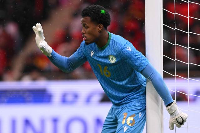 Comoros's goalkeeper #16 Yannick Pandor gestures during the Africa Cup of Nations (CAN) group A  football match between Morocco and Comoros at Prince Moulay Abdellah Stadium in Rabat on December 21, 2025. (Photo by SEBASTIEN BOZON / AFP)