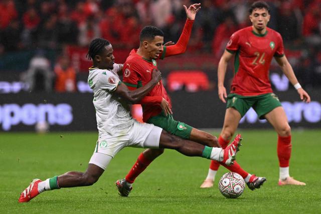 Comoros's defender #02 Ismael Boura (L) fights for the ball with Morocco's midfielder #08 Azzedine Ounahi during the Africa Cup of Nations (CAN) group A  football match between Morocco and Comoros at Prince Moulay Abdellah Stadium in Rabat on December 21, 2025. (Photo by SEBASTIEN BOZON / AFP)