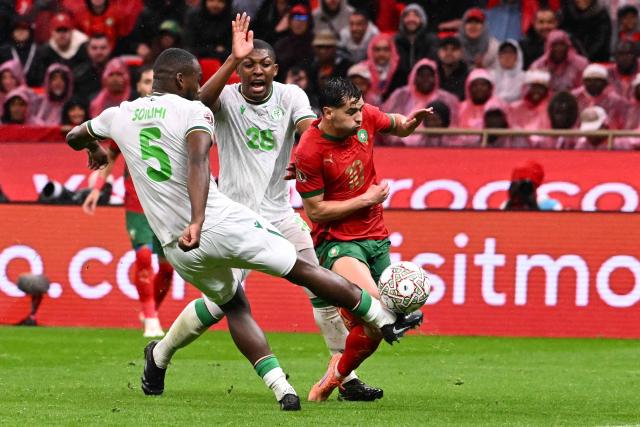Morocco's forward #10 Brahim Diaz fights for the ball with Comoros's defender #05 Ahmed Soilihi and Comoros's midfielder #28 Zaydou Youssouf during the Africa Cup of Nations (CAN) group A  football match between Morocco and Comoros at Prince Moulay Abdellah Stadium in Rabat on December 21, 2025. (Photo by SEBASTIEN BOZON / AFP)