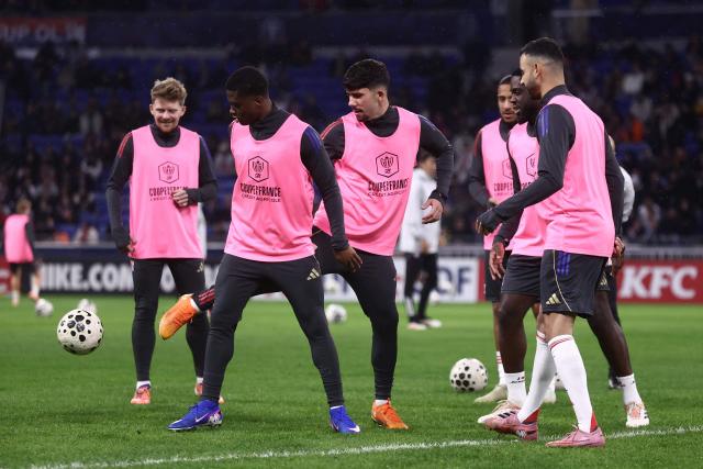 Lyon's players warm up ahead of the French Cup round of 64 football match between - Olympique Lyonnais (OL) and Saint-Cyr-Collonges at the Groupama Stadium in Lyon, south eastern France on December 21, 2025. (Photo by Alex MARTIN / AFP)